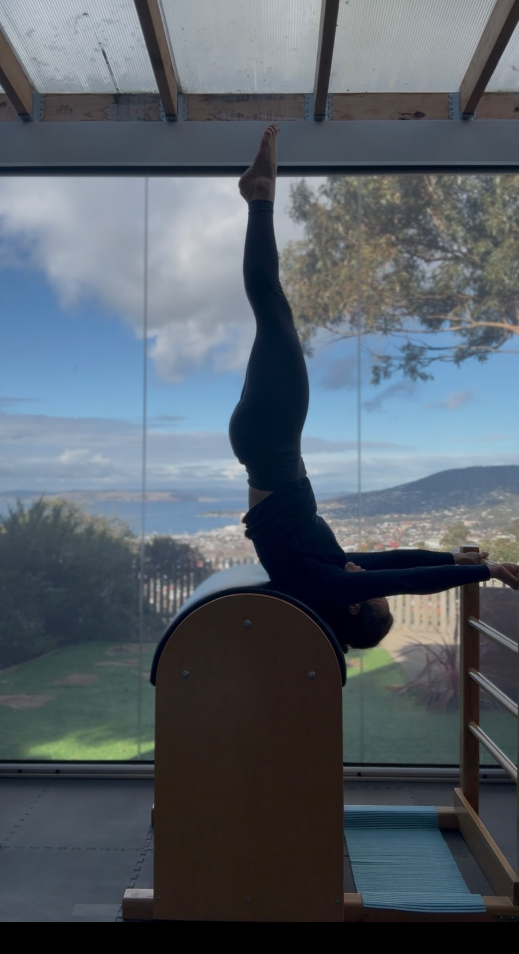 Client performing a ladder barrel exercise overlooking Hobart